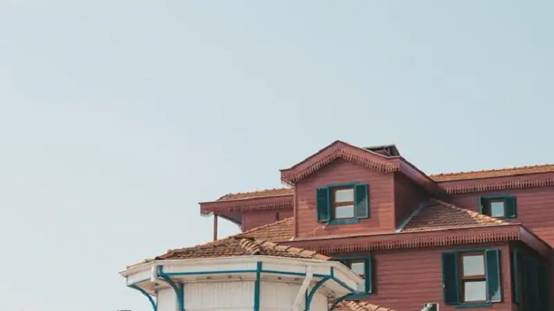 Exterior of an older house with visible attic windows